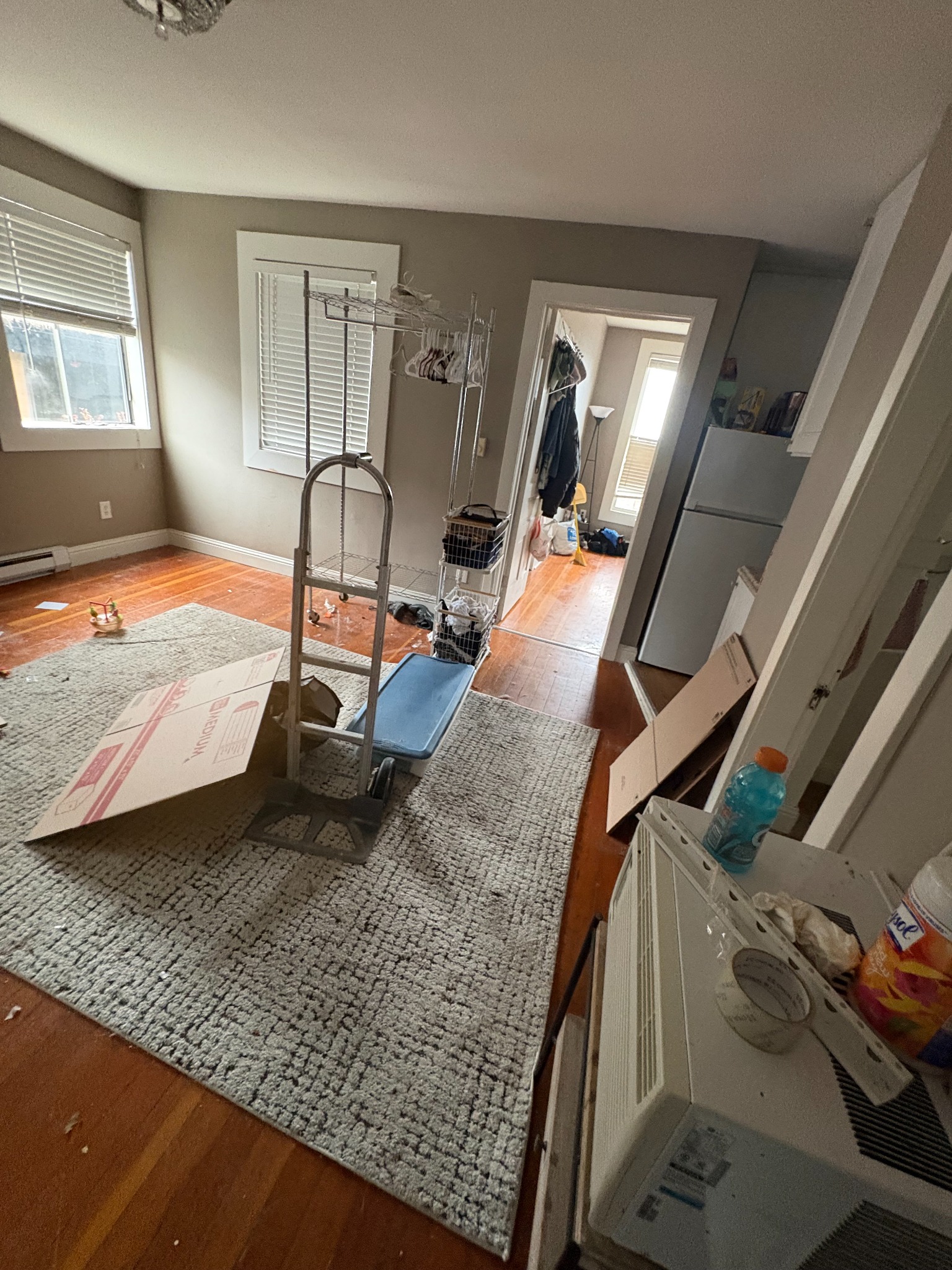 Move-out cleaning before photo showing cluttered room